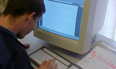 image of a young person working at a computer