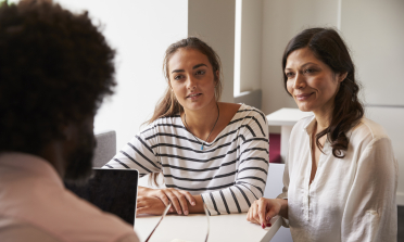 A mother and daughter meet with a teacher