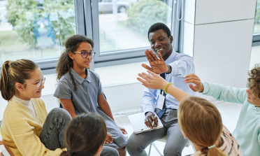 image of teacher and pupils in discussion