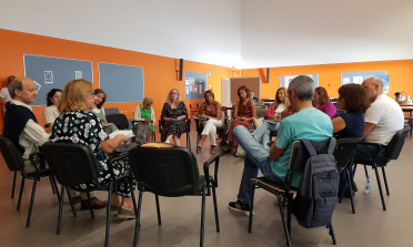 A group of people sit in a circle