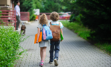 Two children walking to school