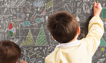 children writing on a blackboard