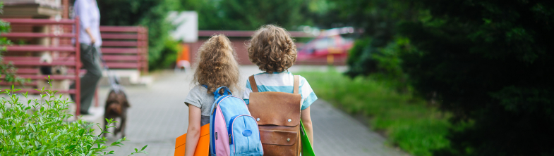 Two children walking to school