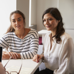 A mother and daughter meet with a teacher